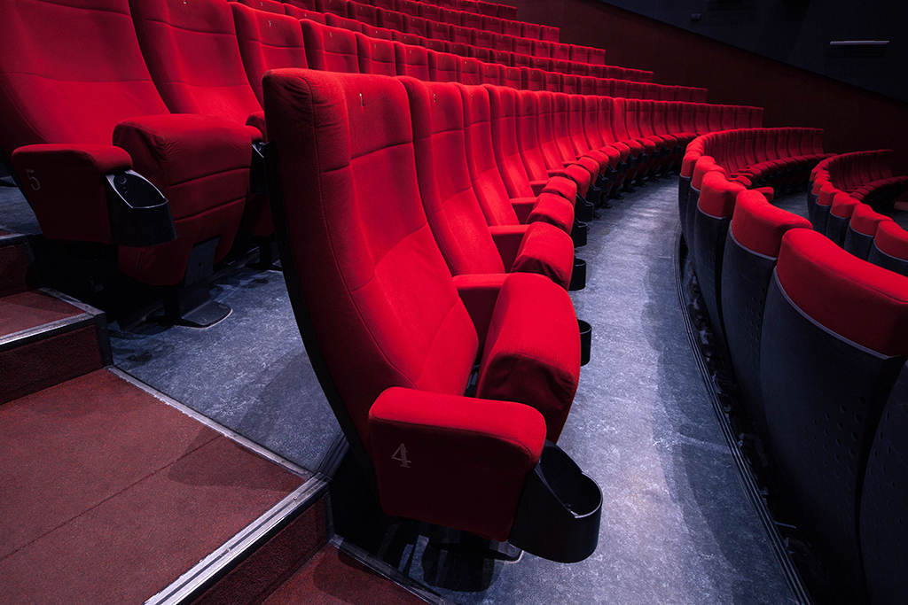 Cinema auditorium with one reserved seat