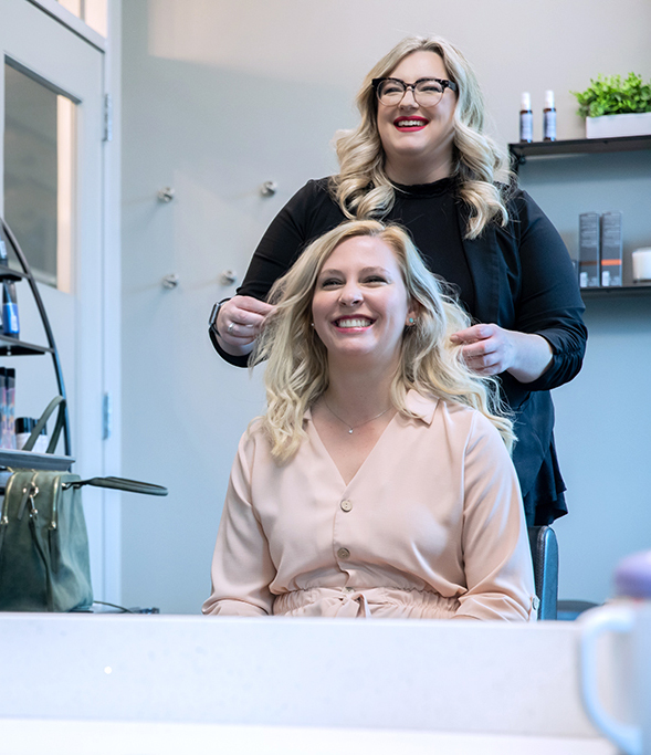 woman smiling at the hairdresser