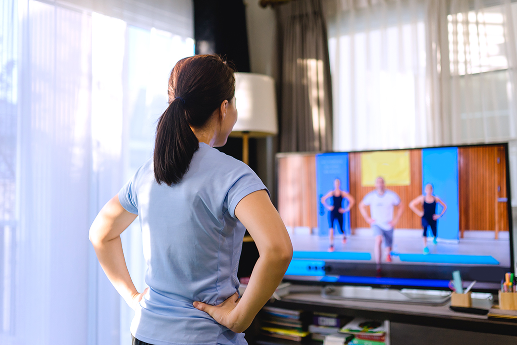 woman joining to an online workout class from home