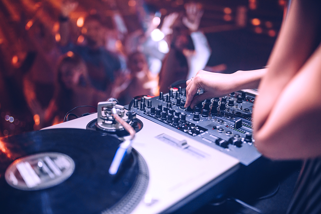 Cropped shot of a DJ playing music at the club